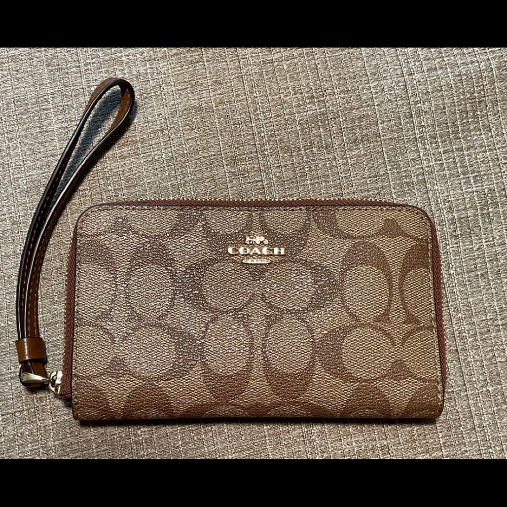 Brown leather coach wristlet.
